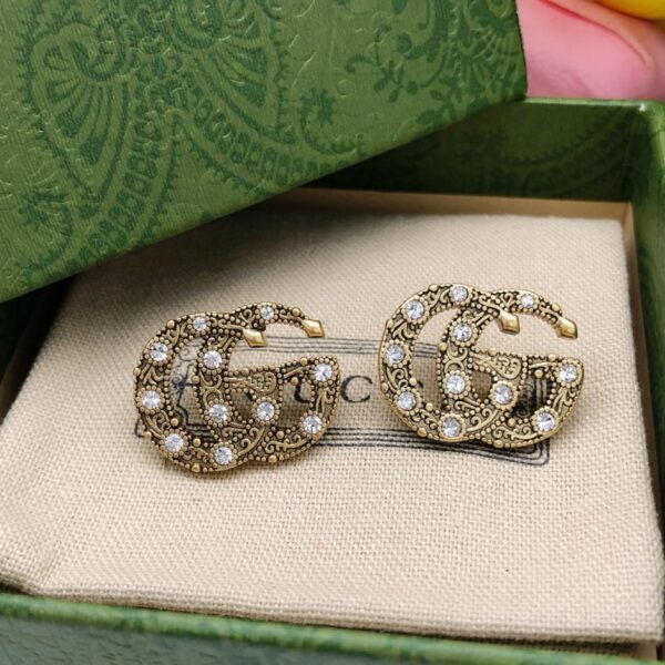 replica,repliche,fake,1:1,earrings,bracelet,ring,jewelry Orecchini Gucci con doppia G twist e diamanti (8A75)