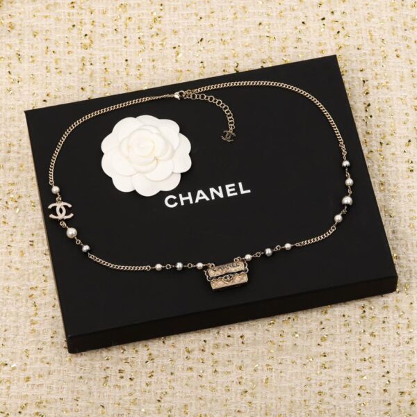 replica,repliche,fake,1:1,earrings,bracelet,ring,jewelry Collana Chanel con borsa in pizzo nero