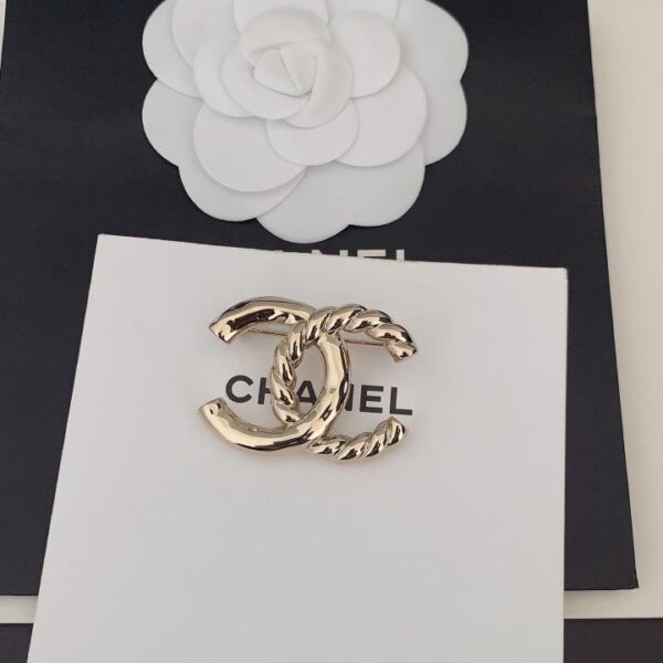 replica,repliche,fake,1:1,earrings,bracelet,ring,jewelry Ultima spilla twist in oro chiaro Chanel (5E4A)