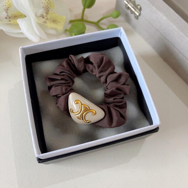 Viene fornito con confezione (singola) elastico per capelli CELINE Arc de Triomphe