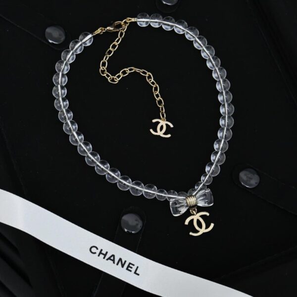 replica,repliche,fake,1:1,earrings,bracelet,ring,jewelry Collana Chanel con fiocco trasparente in acrilico da 25 pence (HAD6E)