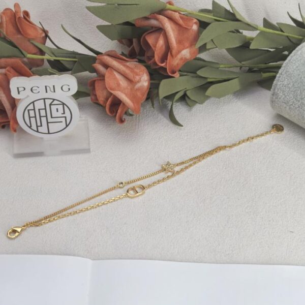 Bracciale Dior a doppio strato con stella a cinque punte e diamanti, versione da banco, placcato oro 18 carati, colore preservato (DQD36)